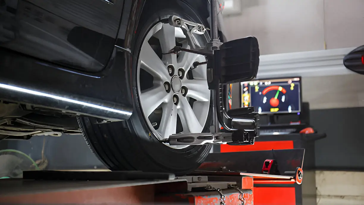 A close-up of a vehicle undergoing a precise computerized wheel alignment service in Hamilton to enhance driving stability and tire performance.