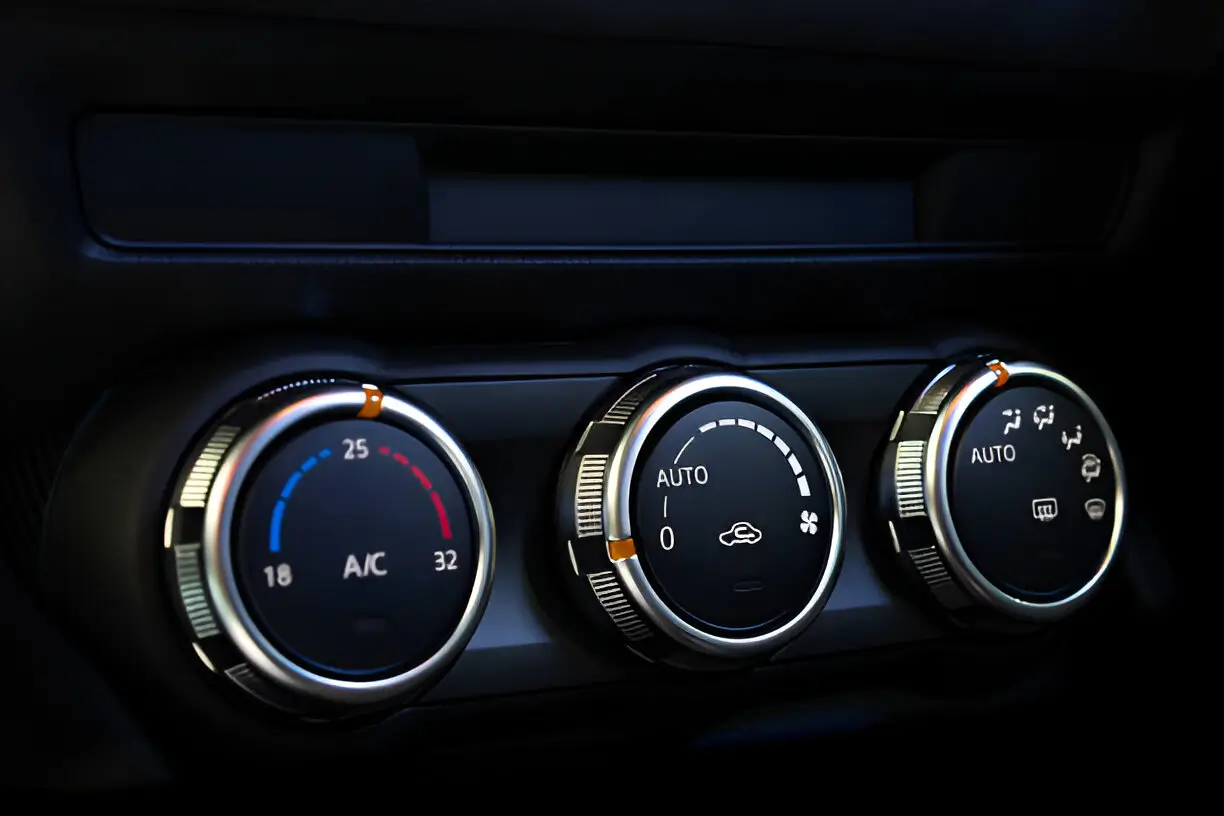 Close-up of car air conditioning control knobs, representing air conditioning service in Hamilton.