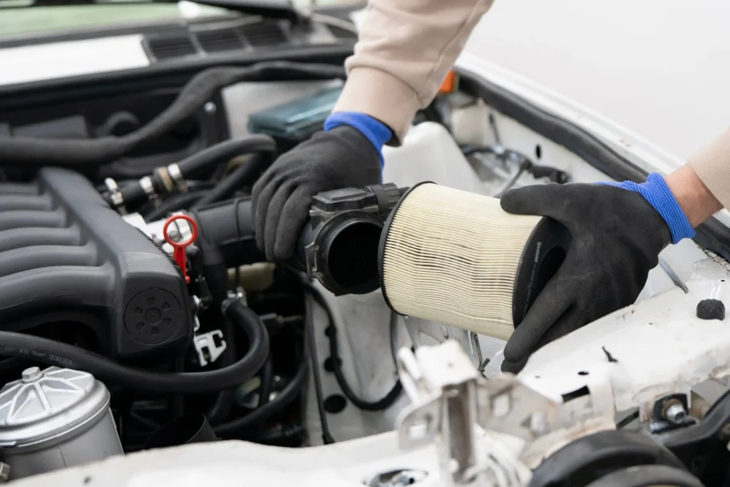 Technician replacing engine air filter during regular preventive maintenance service.